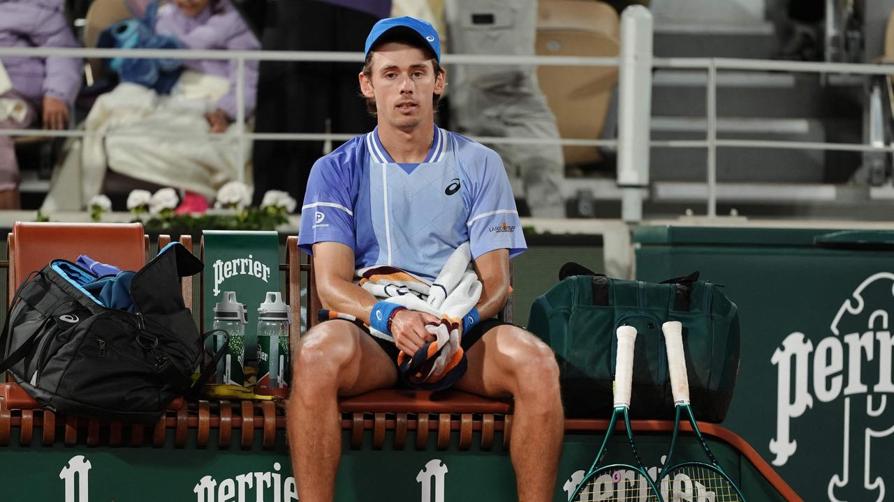 Australia's Alex De Minaur looks disappointed as he sits on the bench during his quarter final match at the French Open. Picture: AFP