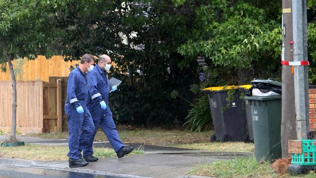 Forensic officers inspect the street outside the property. Picture: Yuri Kouzmin