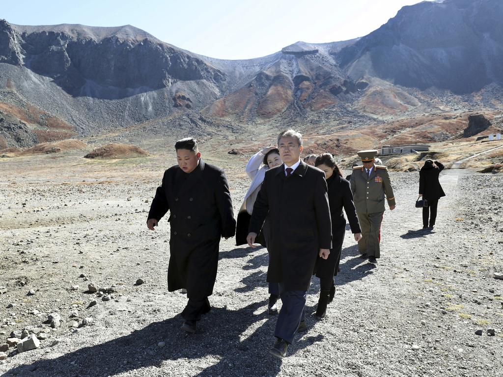 North Korean leader Kim Jong-un, left, and South Korean President Moon Jae-in visit Mount Paektu, in North Korea. Picture: Pyongyang Press Corps Pool via AP