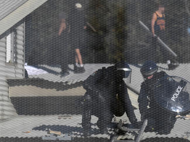 Detainees and Riot police are seen during a riot at the Frank Baxter Juvenile Justice Centre, Kariong, NSW, Monday, July 22, 2019. (AAP Image/Dean Lewins)