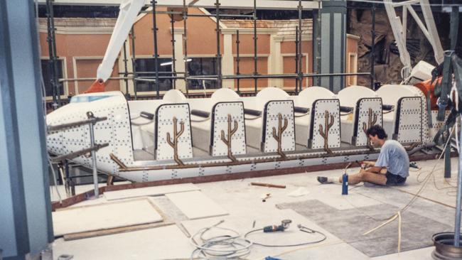 Workers working on rollercoaster carriage during construction of the Myer Centre, Brisbane, 1988. Photo: Gil Meland/State Library of Queensland