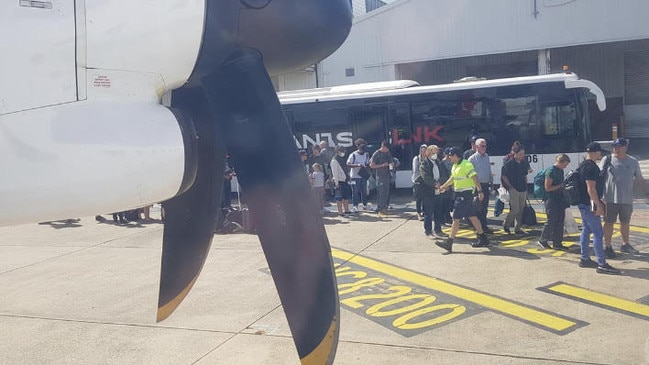 Airports and airlines have escaped the tough social distancing regulations implemented across other sectors. Passengers who took the QF1419 from the NSW capital to Canberra at midday were herded in to one bus to make the trip across the tarmac to their waiting aircraft. Picture: Supplied