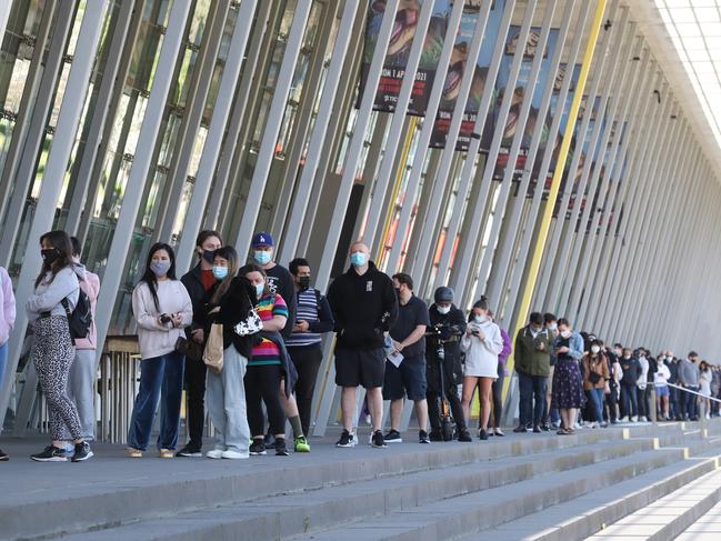 People line up for their Covid vaccination at the Melbourne Exhibition Centre. Picture: David Crosling