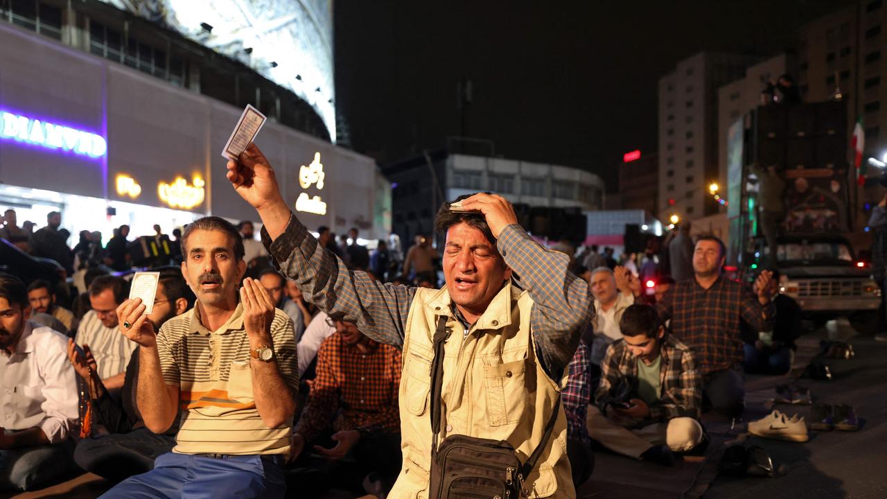 Iranians pray for President Ebrahim Raisi and Foreign Minister Hossein Amir-Abdollahian in central Tehran. Picture: AFP