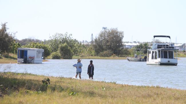 People walking around the island, with boats anchored just off shore. Picture: Richard Gosling.
