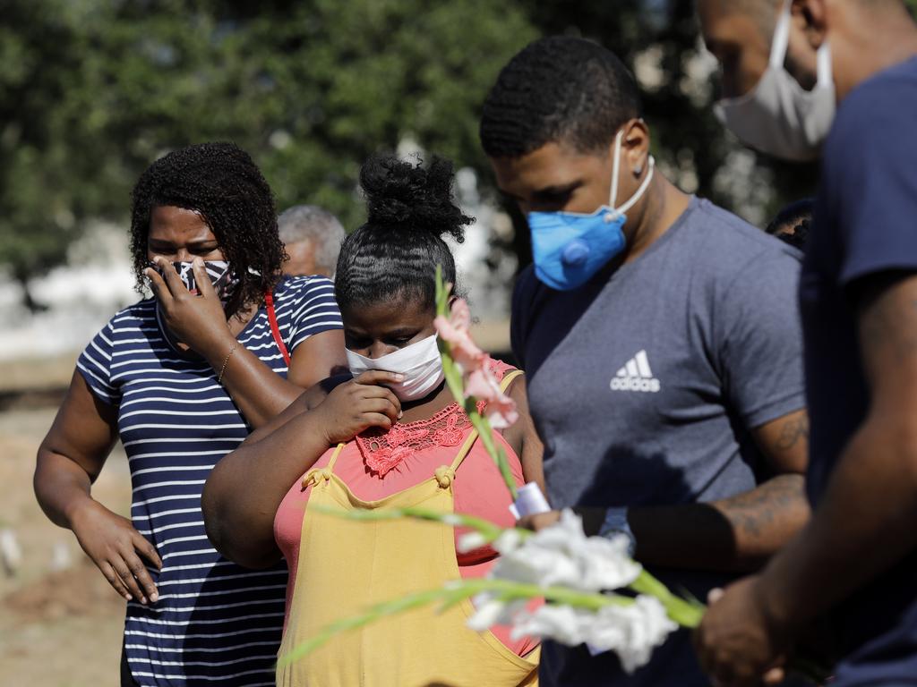 Relatives attend a burial in Rio de Janeiro, Brazil, where cases of coronavirus are rising. Picture: AP Photo/Silvia Izquierdo