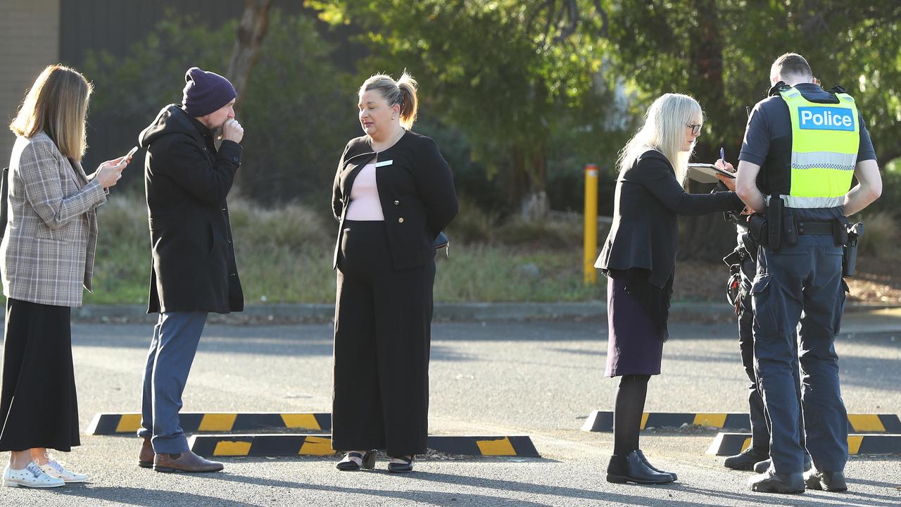 Staff speak with police after a fire caused significant damage to the Hendy St Northern Bay school campus. Picture: Alison Wynd