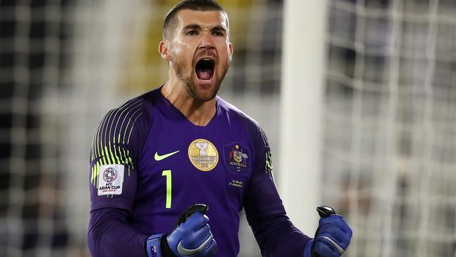 AL AIN, UNITED ARAB EMIRATES - JANUARY 21: Mat Ryan of Australia celebrates after saving the fourth penalty from Marat Bikmaev of Uzbekistan (not pictured) in the penalty shoot out during the AFC Asian Cup round of 16 match between Australia and Uzbekistan at Khalifa Bin Zayed Stadium on January 21, 2019 in Al Ain, United Arab Emirates. (Photo by Francois Nel/Getty Images)