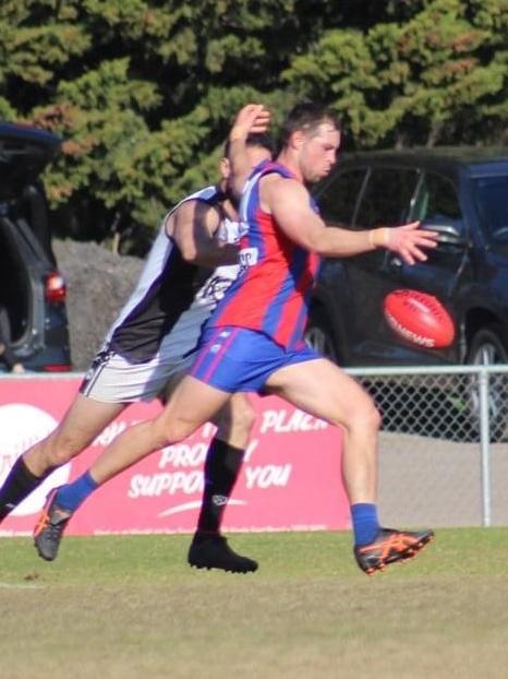 Min gets a kick away for the Demons. Picture: Lisa Wright