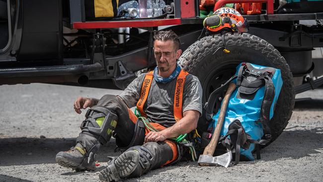 An exhausted Gareth Desmond from Tree Crew takes a break at CFS marshalling area at Oakbank Oval. Picture: Brad Fleet