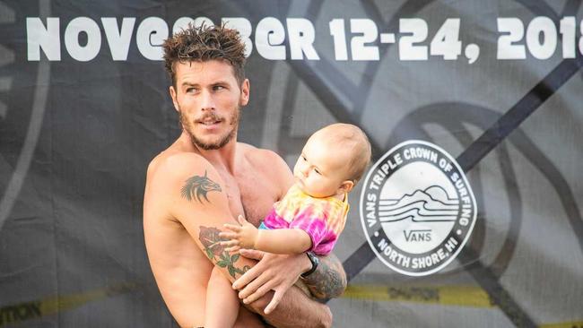 Jack Freestone of Australia and his daughter on Day 3 of the Hawaiian Pro at Haleiwa, Oahu, Hawaii, USA. Picture: Tony Heff