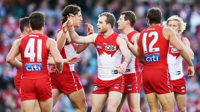 Swan Tom Mitchell celebrates with his Sydney team mates.