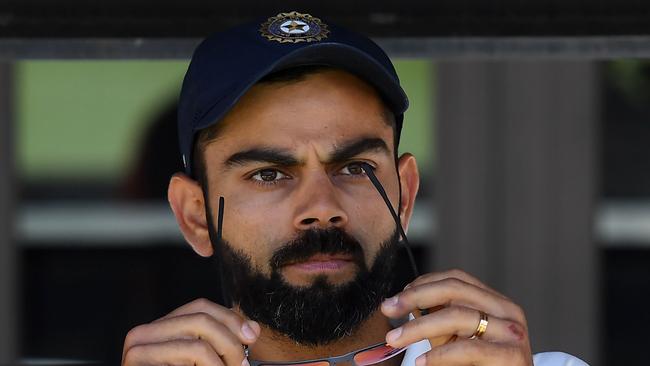 India's captain Virat Kohli (C) sits on the players bench at the end of second Test cricket match between Australia and India in Perth on December 18, 2018. (Photo by WILLIAM WEST / AFP) / -- IMAGE RESTRICTED TO EDITORIAL USE - STRICTLY NO COMMERCIAL USE --