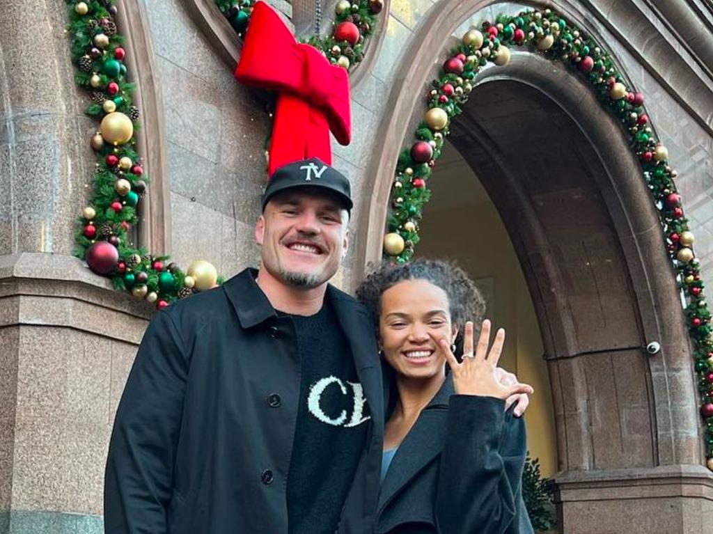 Angus Crichton and his partner, Chloe Esegbona, celebrate their engagement outside the Midlan Hotel in Manchester. Picture: Instagram