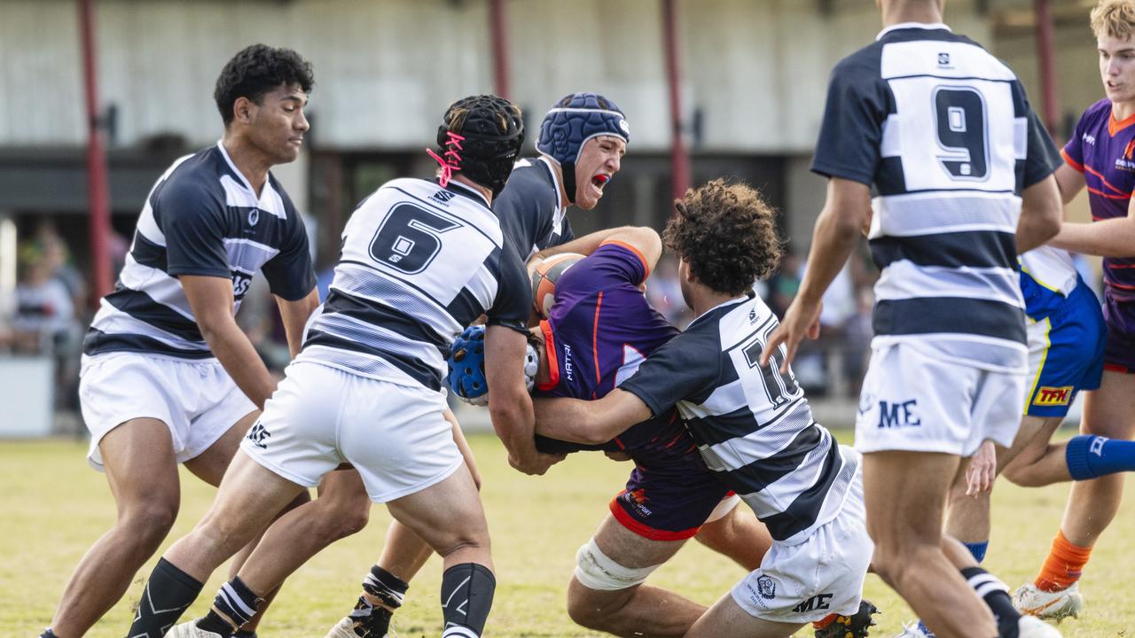 Sam Human of Sunshine Coast is tackled by Met East players.