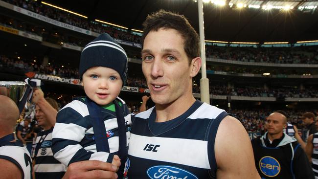 Harry Taylor and his son James after the 2011 grand final.