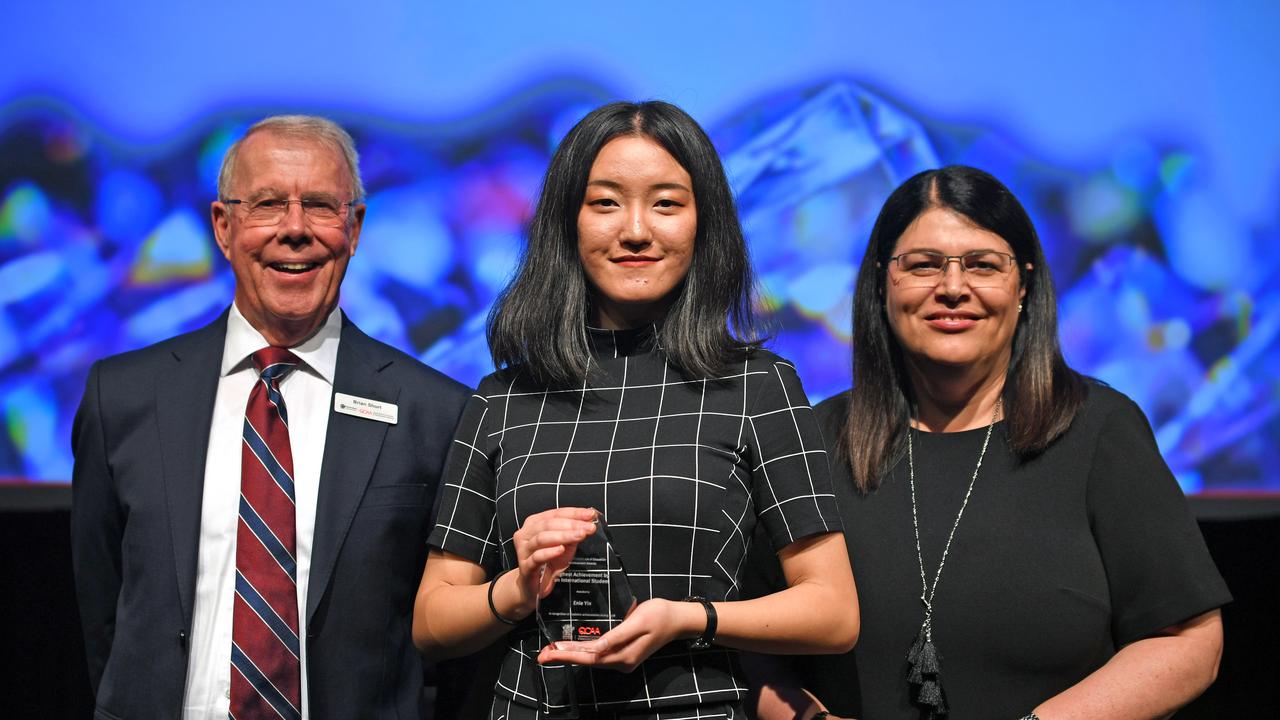 Student Enle Yin with chairman of QCAA Brian Short and MP Grace Grace. The Citipointe Christian College’s student won the award for the Highest Achievement by an International Student. Picture: AAP/John Gass