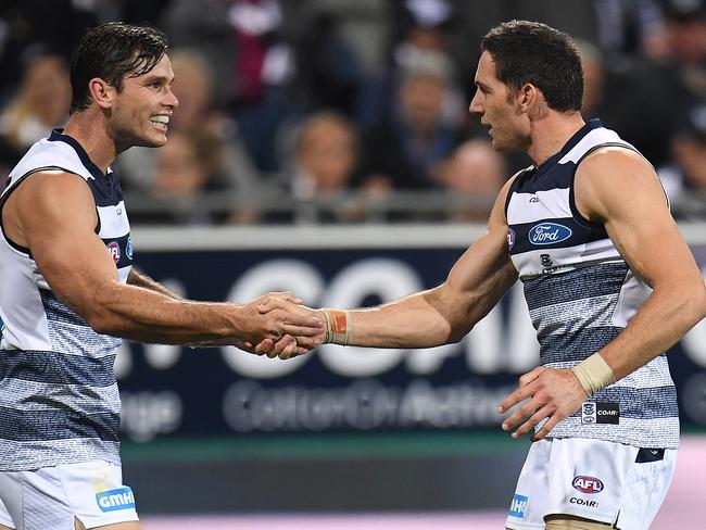 Geelong players Tom Hawkins (left) and Harry Taylor celebrate.