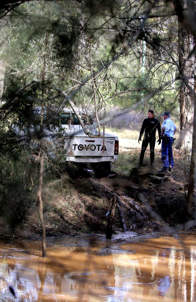 Police retrieve the car of a man who drowned after the ute was washed away at Leppington. Picture Stephen Cooper