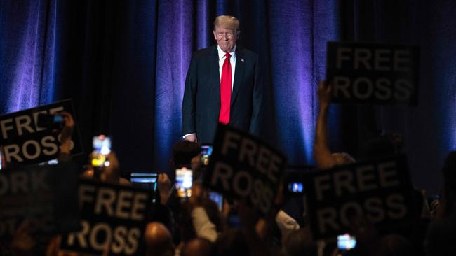 People hold up signs reading ‘Free Ross’ as Mr Trump arrives to address the Libertarian National Convention in Washington. Ross Ulbricht, the founder of the online marketplace Silk Road for the sale of heroin, cocaine, LSD and other illegal drugs, was sentenced to life in prison in 2015. Picture: AFP