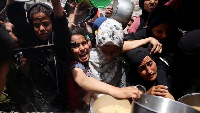 Palestinians struggle to get their food rations outside a crowded distribution centre in Beit Lahia in the northern Gaza Strip. Picture: AFP