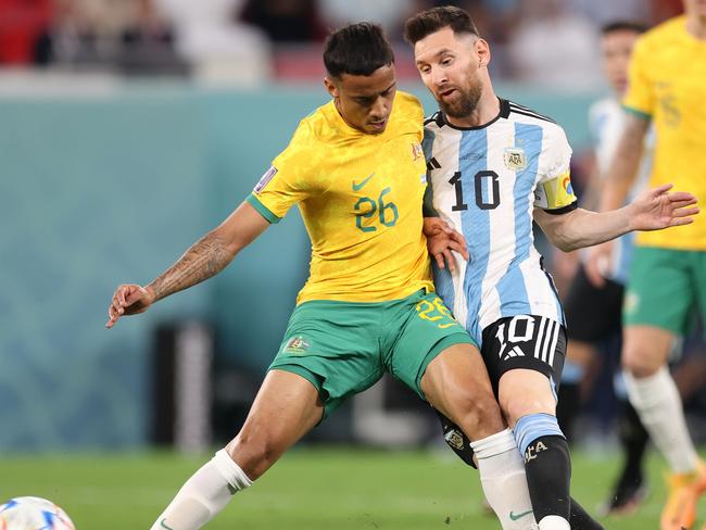 DOHA, QATAR - DECEMBER 03: Lionel Messi of Argentina battles for possession with Keanu Baccus of Australia during the FIFA World Cup Qatar 2022 Round of 16 match between Argentina and Australia at Ahmad Bin Ali Stadium on December 03, 2022 in Doha, Qatar. (Photo by Alex Pantling/Getty Images)