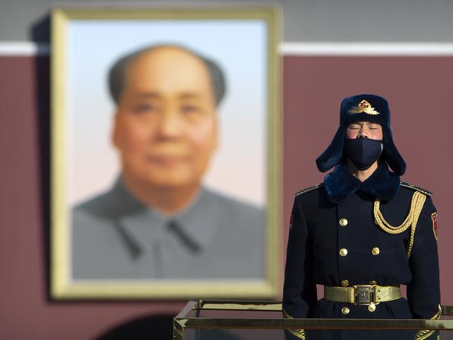 A member of a Chinese honor guard wears a face mask as he stands guard on Tiananmen Square in Beijing, Tuesday, Feb. 4, 2020. China said Tuesday the number of infections from a new virus surpassed 20,000 as medical workers and patients arrived at a new hospital and President Xi Jinping said "we have launched a people's war of prevention of the epidemic." (AP Photo/Mark Schiefelbein)