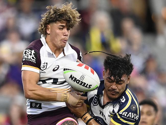 TOWNSVILLE, AUSTRALIA - AUGUST 10: Reece Walsh of the Broncos and Jeremiah Nanai of the Cowboys contest the ball during the round 23 NRL match between North Queensland Cowboys and Brisbane Broncos at Qld Country Bank Stadium, on August 10, 2024, in Townsville, Australia. (Photo by Ian Hitchcock/Getty Images)