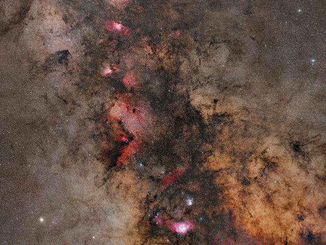 Starlight and Silhouettes ... Taken over 4 years, totaling 110 hours and comprising of 36 panes, this image showcases the summer skies as seen from the northern hemisphere. The photograph reveals intricate details of our galaxy, the Milky Way that would be invisible to the naked eye. Glowing red hydrogen gas nebulae appear to intertwine with dusky nebulae made of dust, as the blue light of the stars twinkles out from behind them. Picture: Tom O’Donoghue, Insight Astronomy Photographer of the Year 2016 Stars and Nebulae Highly Commended