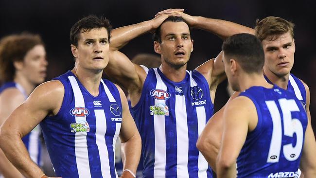 Scott Thompson, Robbie Tarrant, Paul Ahern and Mason Wood after the Kangaroos’ big loss to Essendon. Picture: AAP