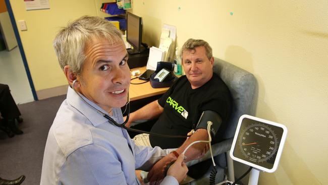 Associate Professor Jonathan Sturm, a neurologist at Gosford and Wyong Hospitals, with volunteer John Breen. Picture: Mark Scott