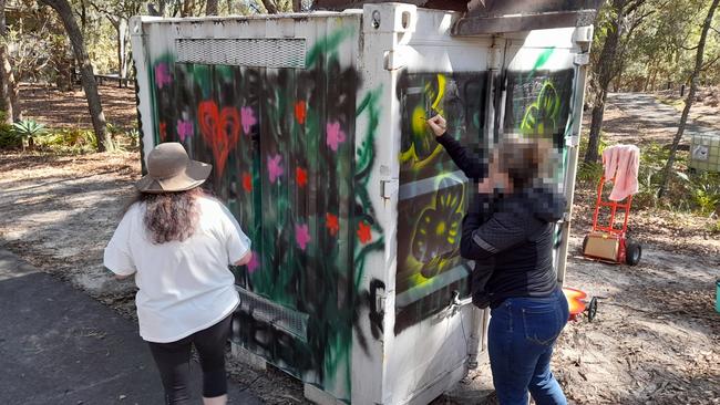 Couran Cove residents have painted over a disturbing message that was written on a shipping container.