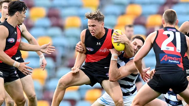 BRISBANE, AUSTRALIA - SEPTEMBER 06: Dylan Clarke of the Bombers attempts to break away from the defence during the round 16 AFL match between the Geelong Cats and the Essendon Bombers at The Gabba on September 06, 2020 in Brisbane, Australia. (Photo by Bradley Kanaris/Getty Images)