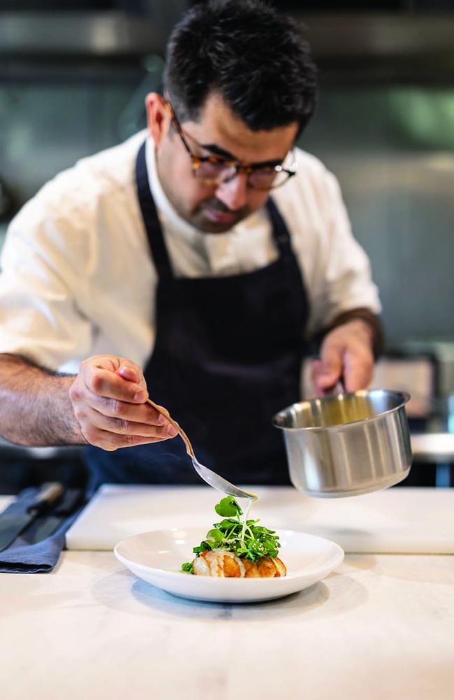 Chef Alex Munoz finishes at dish at Labart. Photo: Jeff Camden
