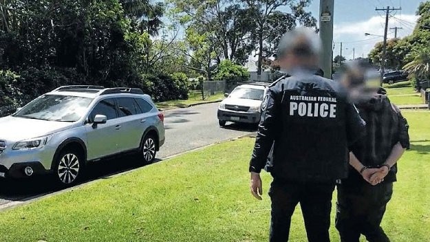 Tyson Murray being arrested by Australian Federal Police officers. Credit: AFP