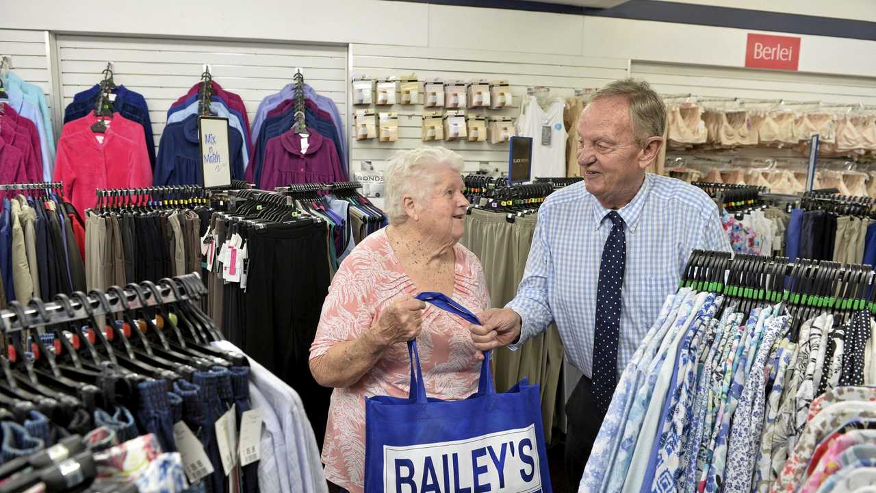 Bev Young has been shopping at   iconic Toowoomba store Bailey's for 65 years. She buys her last purchase with owner Lex Bailey as he announces the business will close, Saturday, January 12, 2019. Picture: Kevin Farmer
