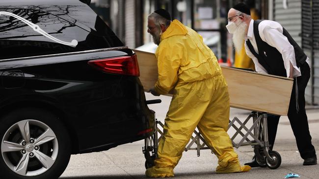 Orthodox Jewish men move a coffin at a funeral home in the Borough Park neighbourhood of New York, which has seen a surge in COVID-19 patients. Picture: AFP