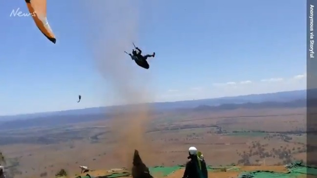 Extraordinary footage of paraglider tossed into air by surprise dust devil