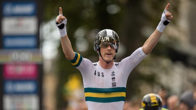 Australia's Rohan Dennis gestures as he passes Slovenia's Primoz Roglic and crosses the line to win the Elite Men Individual Time Trial, over 54 kms from Northallerton to Harrogate, at the 2019 UCI Road World Championships in Harrogate. Picture: Oli Scarff/AFP.