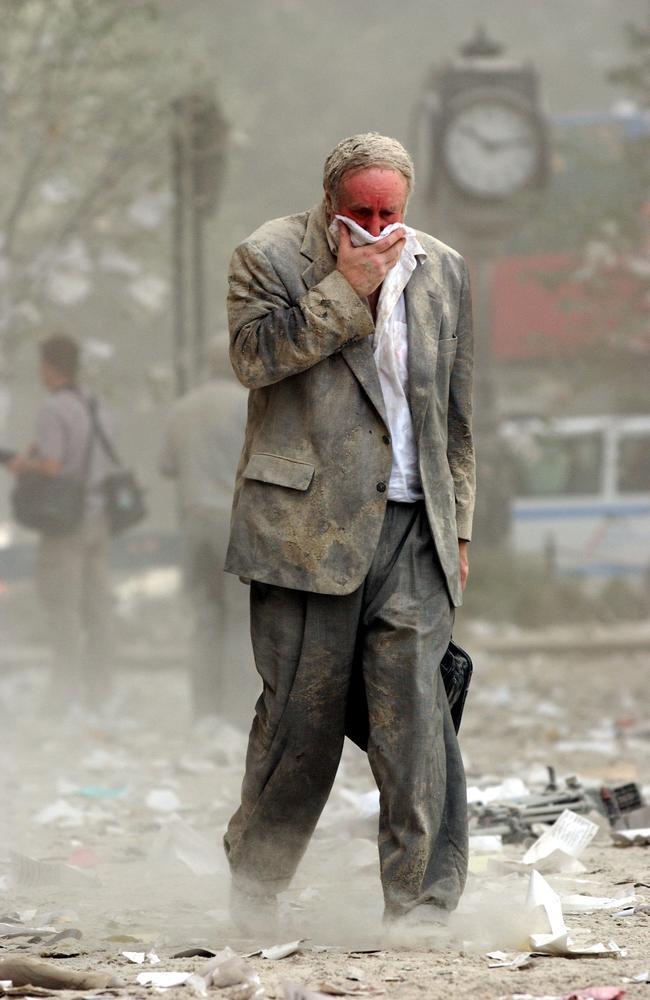 Edward Fine covering his mouth as he walks through the debris after the collapse of one of the World Trade Center Towers in New York. Picture: AFP