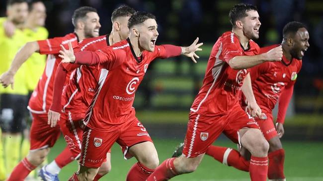 Hume City players celebrate their penalty shootout win. Picture: Teyfik Baser