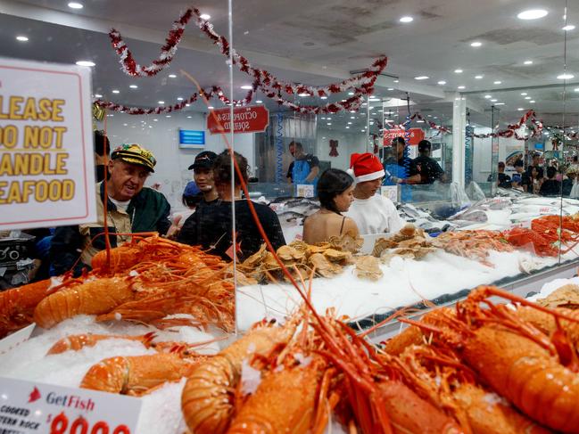 SYDNEY, AUSTRALIA - NewsWire Photos DECEMBER 24, 2024: People queue for seafood at the Sydney Fish Market in Pyrmont on Christmas Eve. Picture: NewsWire / Nikki Short