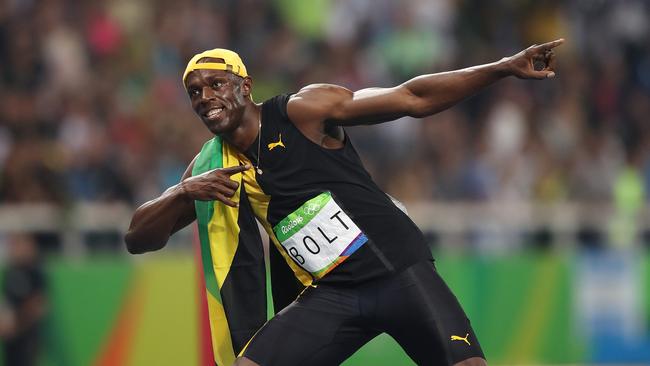 Usain Bolt celebrates winning the gold medal in the men's 100m. Picture: Brett Costello