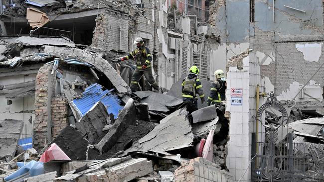 Ukrainian rescuers work at the site of a missile attack in Kyiv which wounded two pregnant women and a teenage girl. Picture: AFP