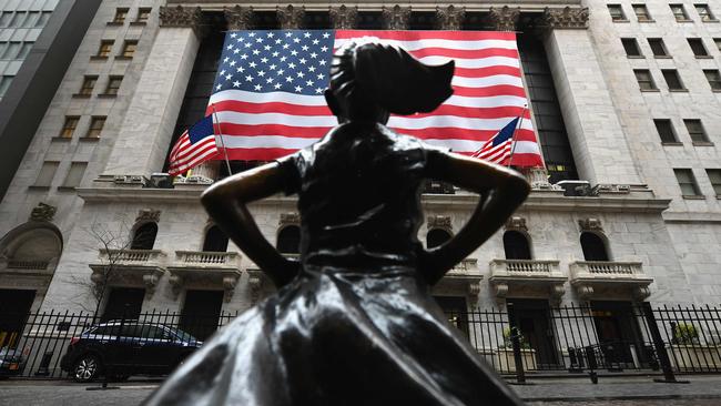 Fearless Girl statue stands in front of the New York Stock Exchange, which has closed its trading floor. Picture: AFP