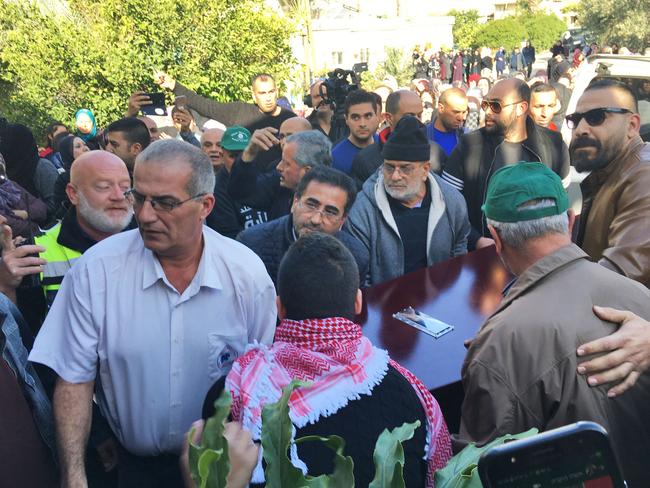 The coffin of Aiia Maasarwe arrives at her family home in the town of Baqa al-Gharibyye. Picture: Ella Pellegrini