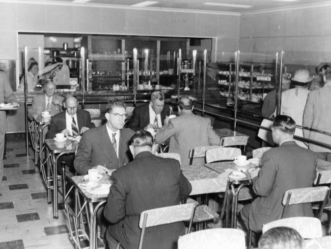 Men enjoying a meal in the Flinders Street Station cafeteria in the 1950s. Picture: State Library Victoria