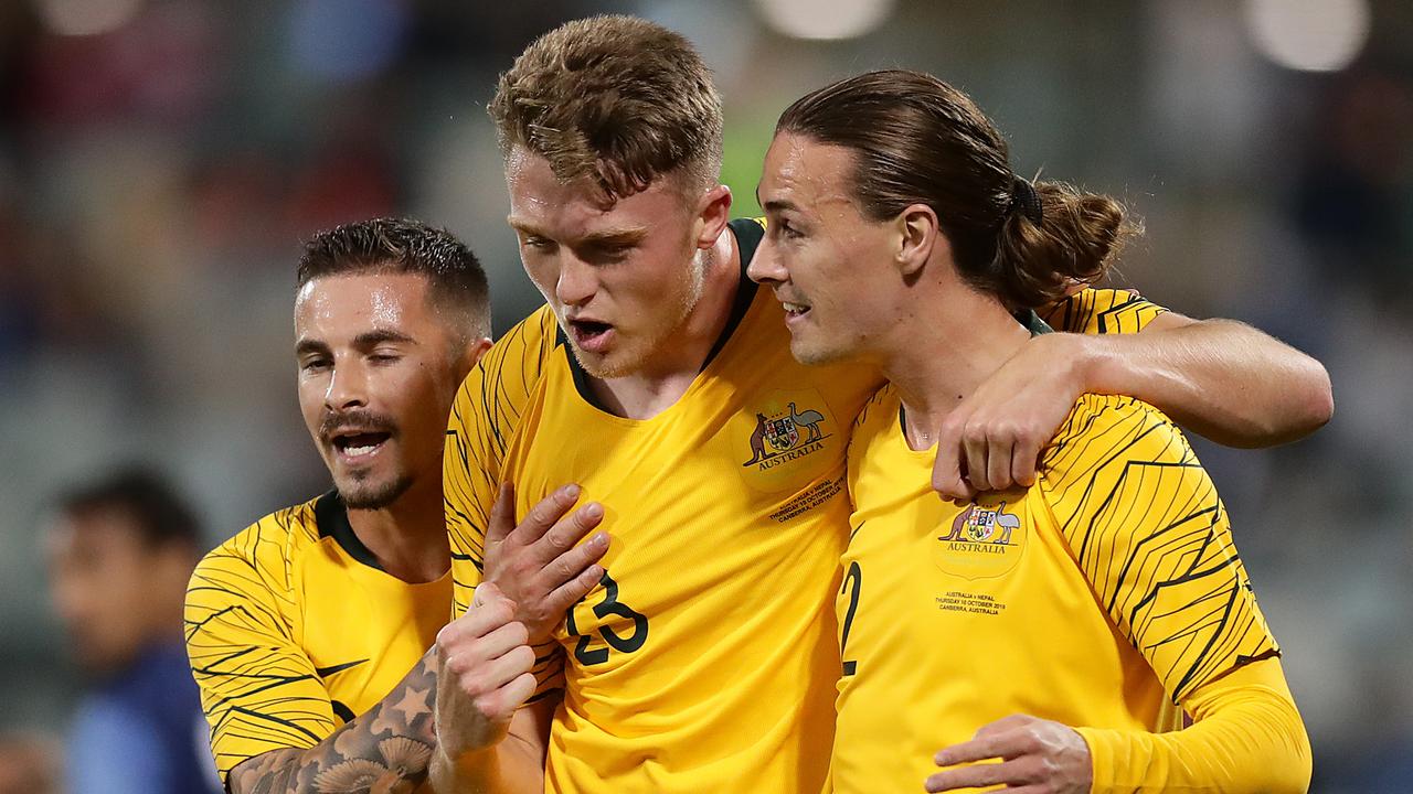 Harry Souttar (centre) celebrates scoring a goal with Socceroos teammates Jamie Maclaren (left) and Jackson Irvine. Picture: Mark Metcalfe / Getty Images