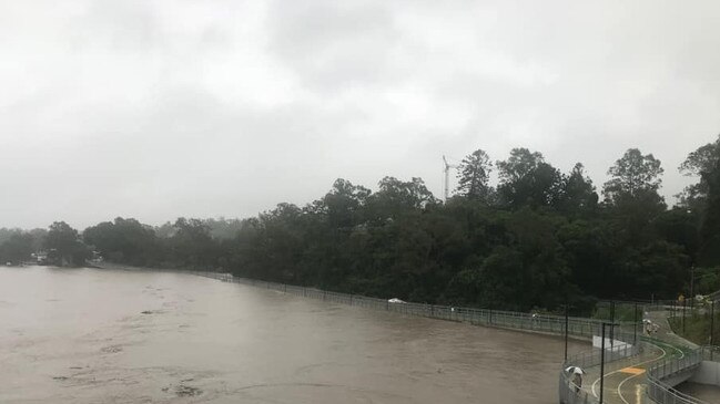 Indooroopilly Riverwalk is nearly submerged, which did not stop someone driving a car over it.