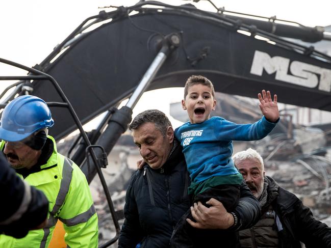 Rescue workers carry eight-year-old survivor Yigit at the site of a collapsed building 52 hours after an earthquake struck in Hatay, Turkey. Picture: Burak Kara/Getty Images